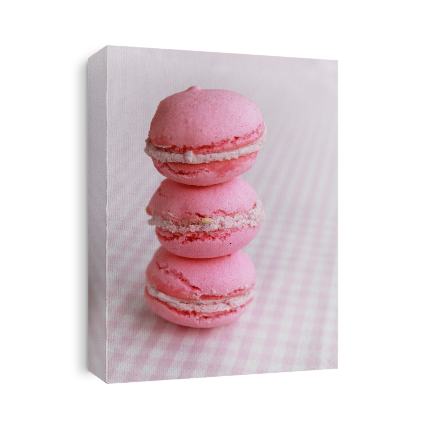 Stack of three pink macaron on a pink background